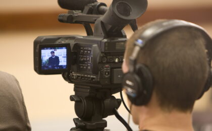 Image of a camera man shooting an interview